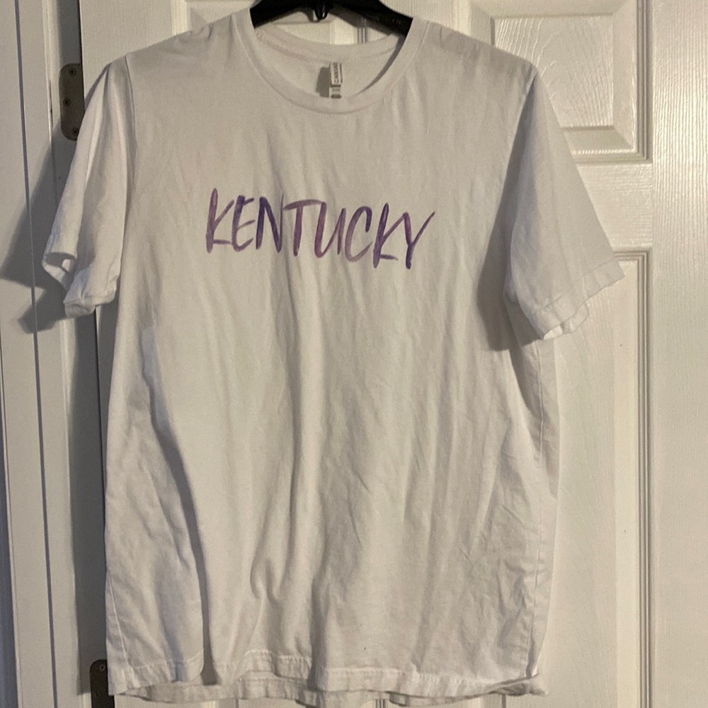 White Kentucky shirt. Writing is purple